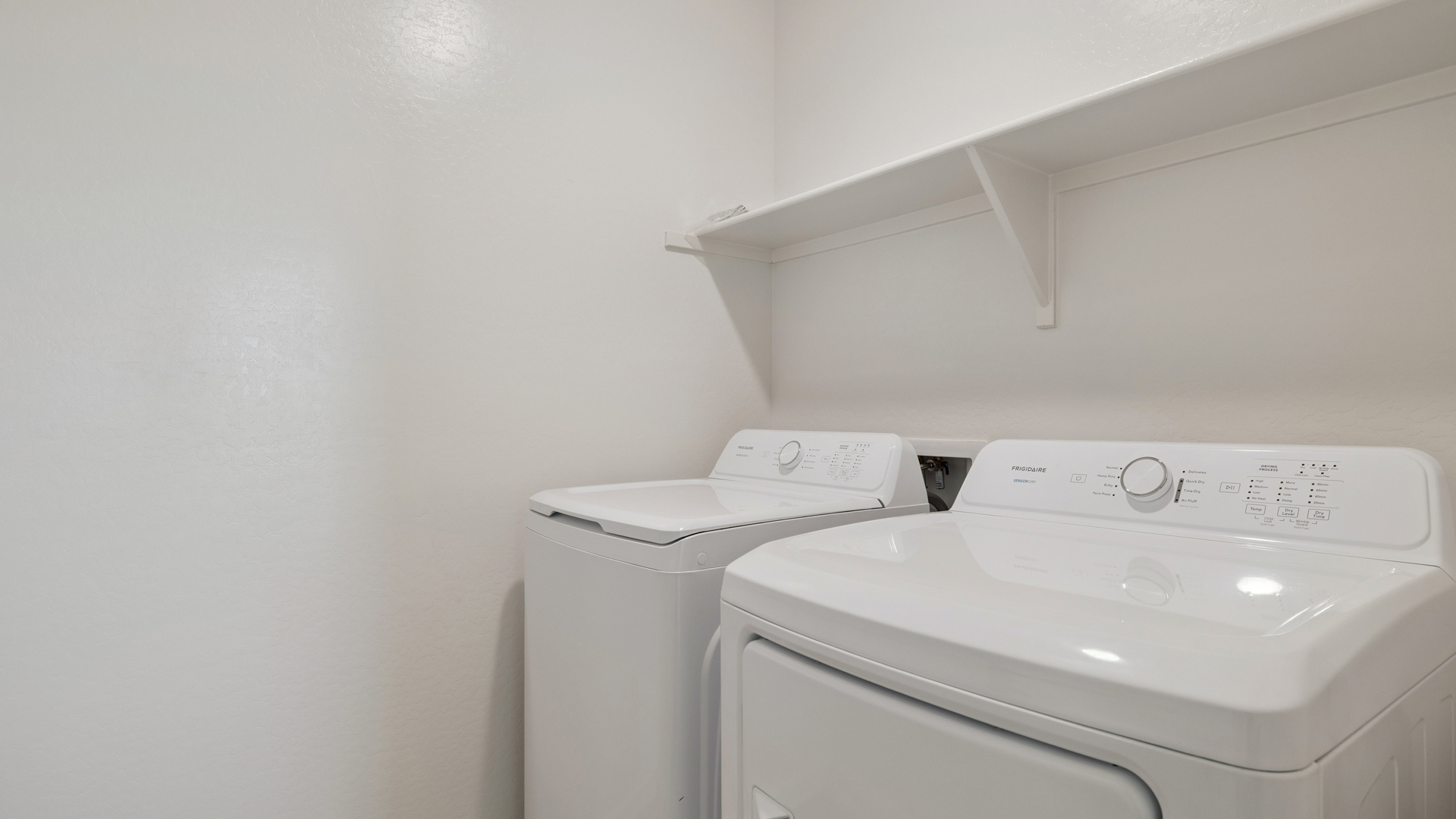Laundry room with shelving.