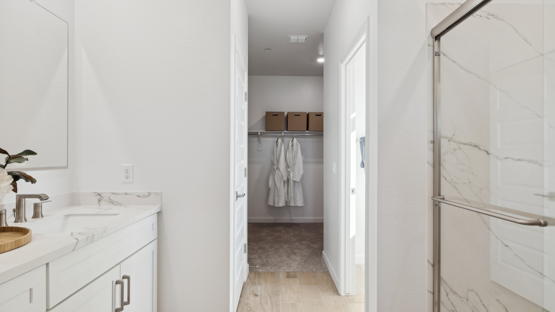 Primary bathroom with dual vanities.