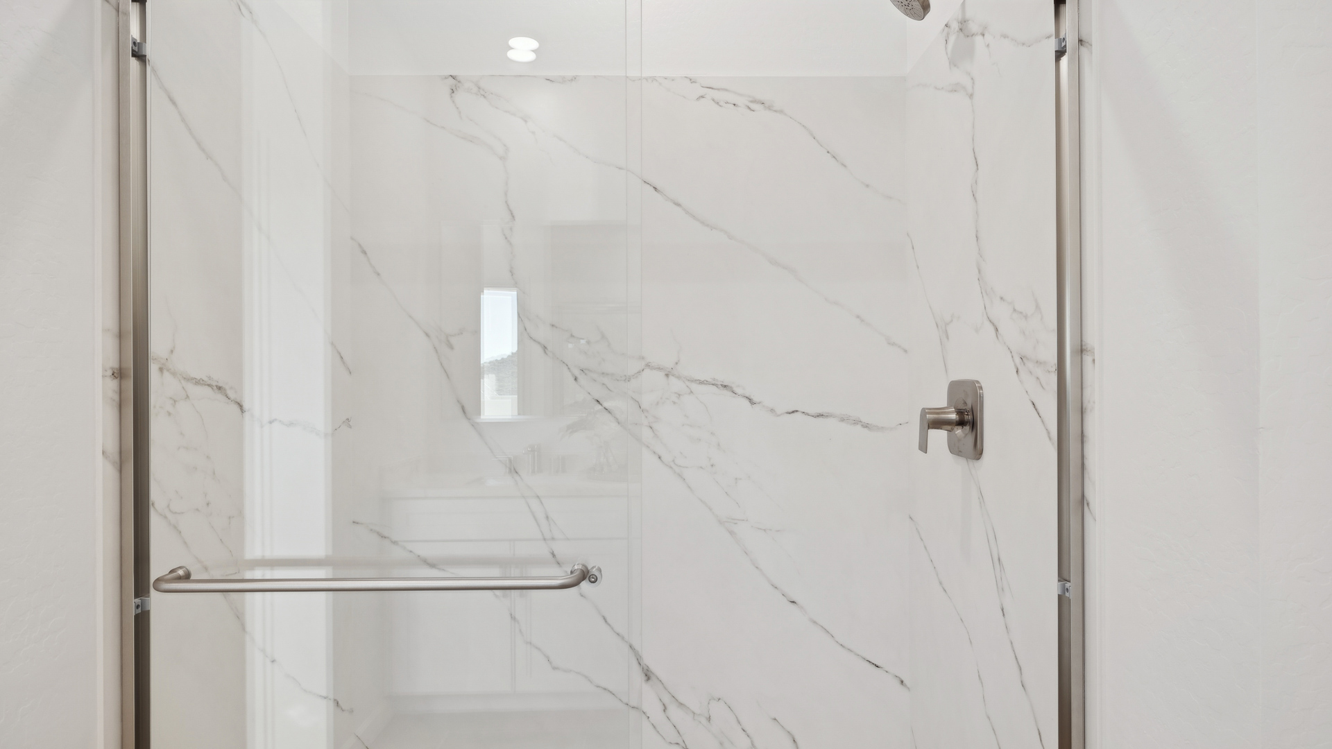 Primary bathroom with dual vanities.