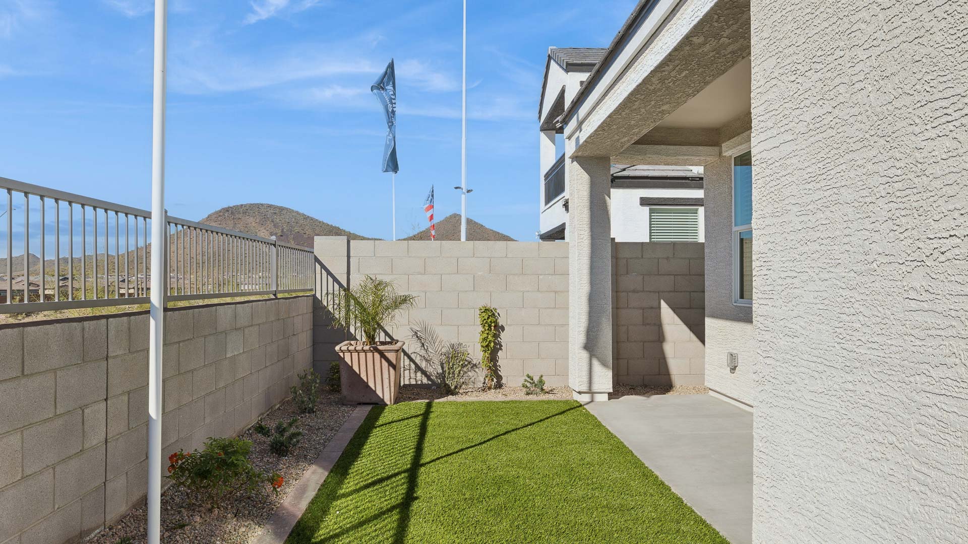 Back yard with turf and covered patio.