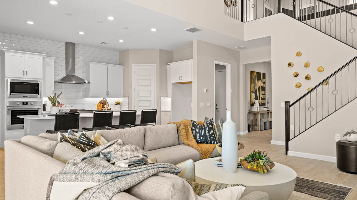 A well-organized living room that includes a kitchen and dining area, creating a warm and welcoming environment for gatherings.
