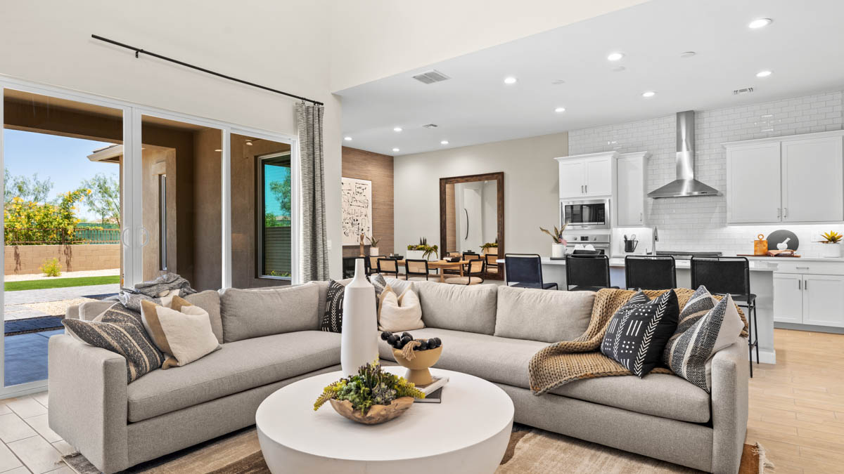 A well-organized living room that includes a kitchen and dining area, creating a warm and welcoming environment for gatherings.