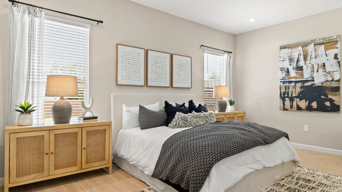 A spacious primary bedroom emphasizing open space and natural lighting.