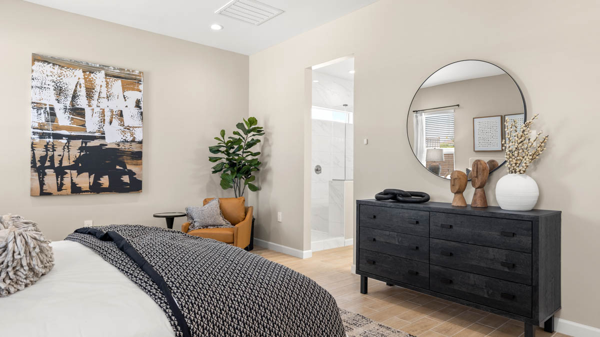 A spacious primary bedroom emphasizing open space and natural lighting.