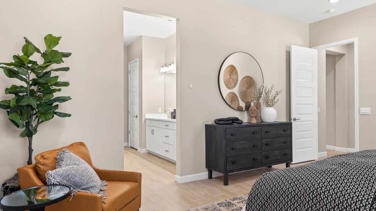 A spacious primary bedroom emphasizing open space and natural lighting.
