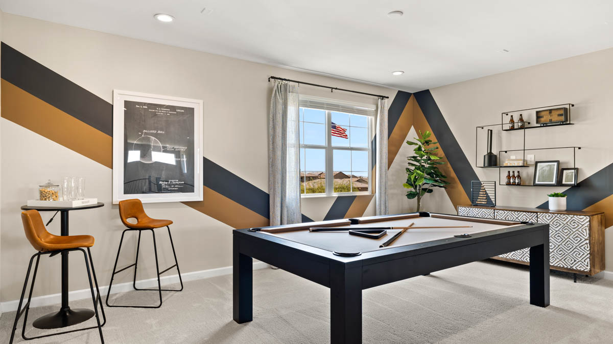 Upstairs play and seating area near large windows and the additional bedrooms.
