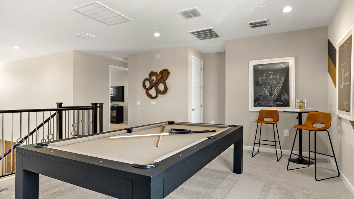 Upstairs play and seating area near large windows and the additional bedrooms.