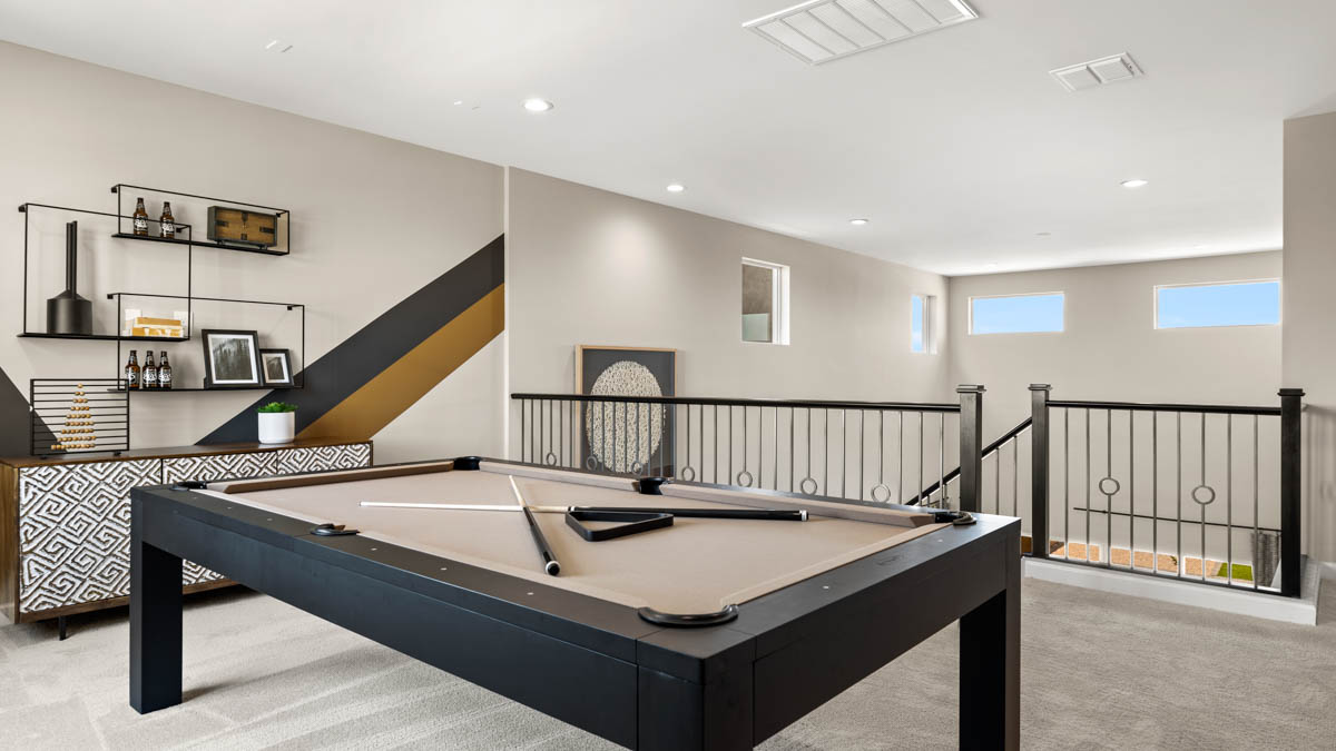 Upstairs play and seating area near large windows and the additional bedrooms.