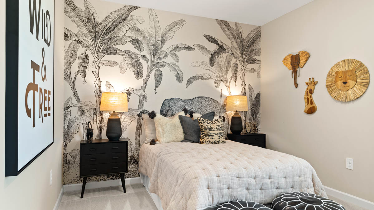 Comfortable guest bedroom featuring neutral-toned walls and a large closet.
