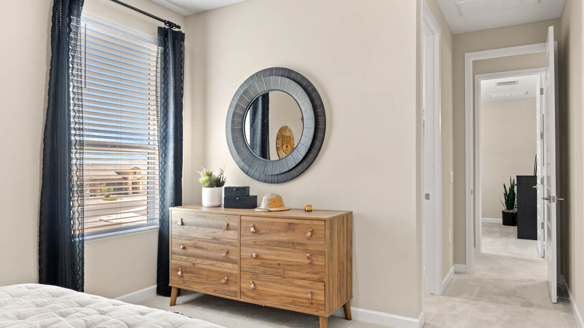 Comfortable guest bedroom featuring neutral-toned walls and a large closet.
