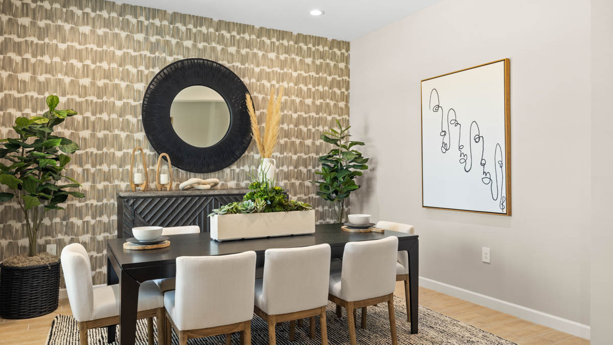Formal dining room with large windows, vinyl wood floors, and view of the living room