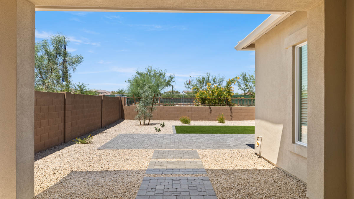 Large fenced-in backyard with a covered patio, perfect for outdoor entertainment.