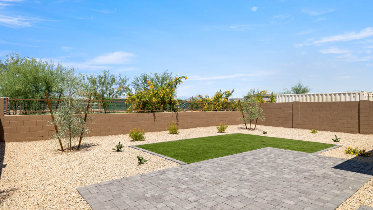 Large fenced-in backyard with a covered patio, perfect for outdoor entertainment.