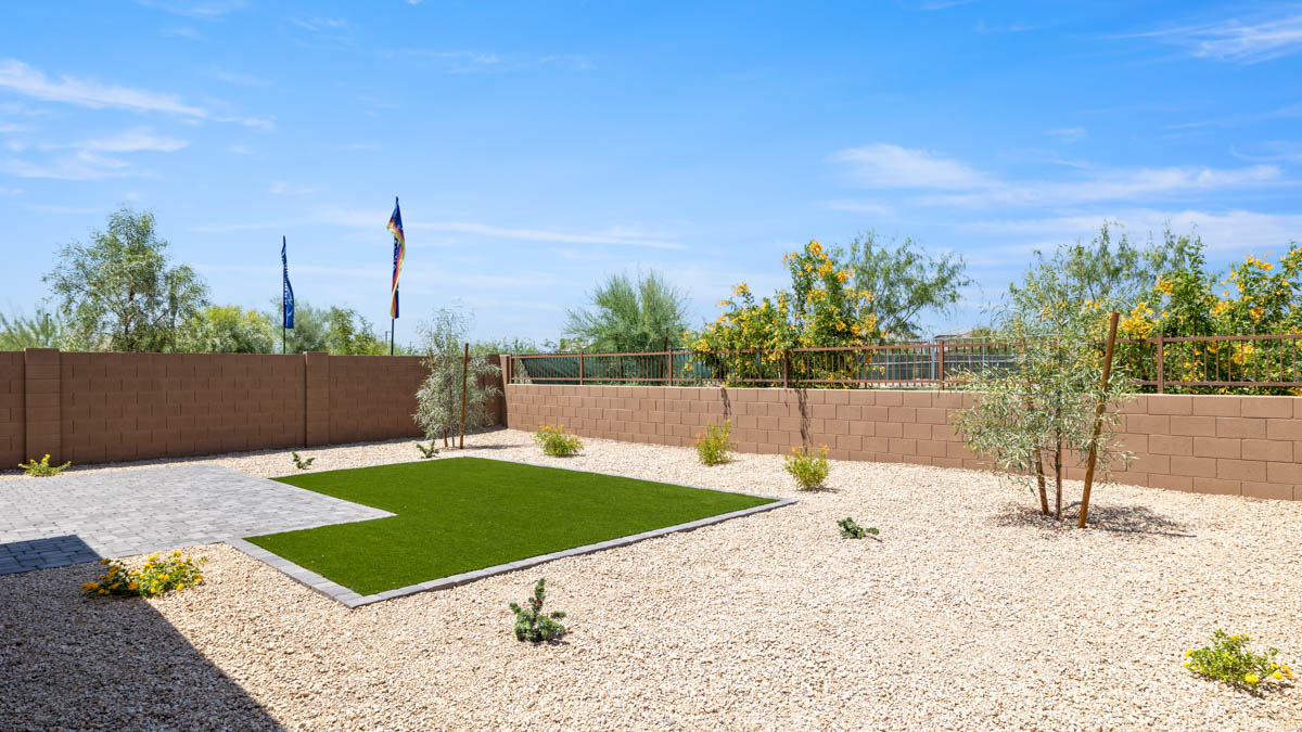 Large fenced-in backyard with a covered patio, perfect for outdoor entertainment.