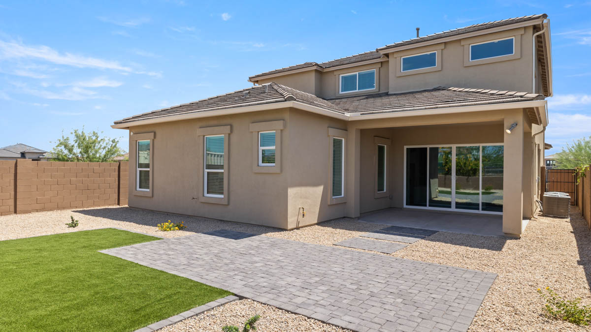 Large fenced-in backyard with a covered patio, perfect for outdoor entertainment.