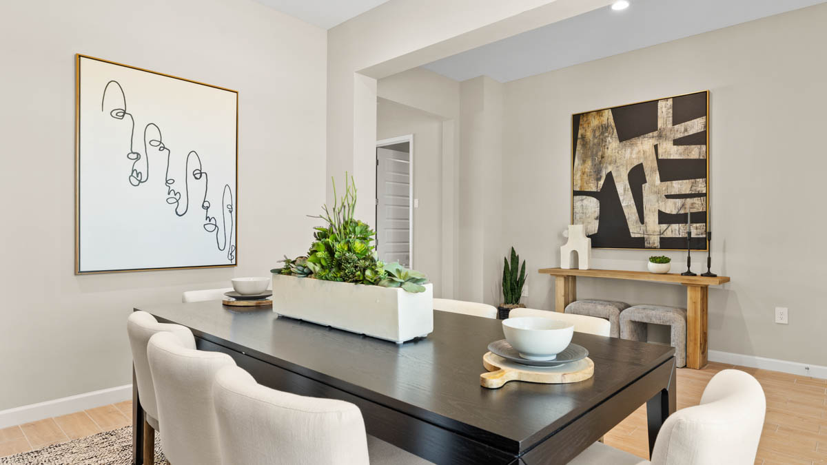 Formal dining room with large windows, vinyl wood floors, and view of the living room