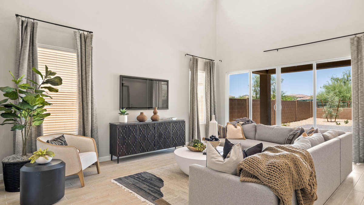 A well-organized living room that includes a kitchen and dining area, creating a warm and welcoming environment for gatherings.