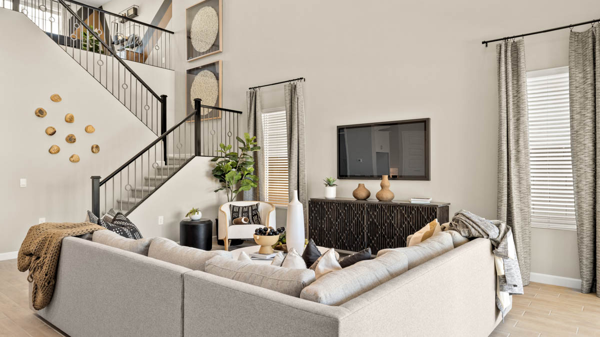 A well-organized living room that includes a kitchen and dining area, creating a warm and welcoming environment for gatherings.