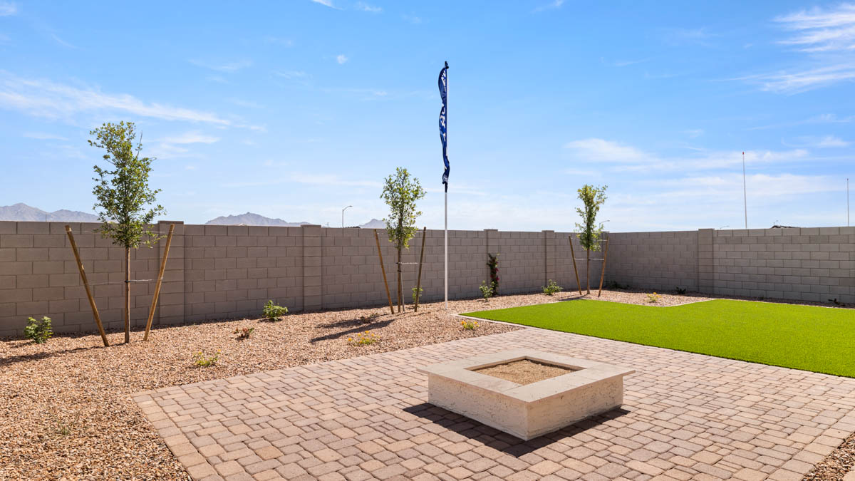 Large fenced-in backyard with a covered patio, perfect for outdoor entertaining.