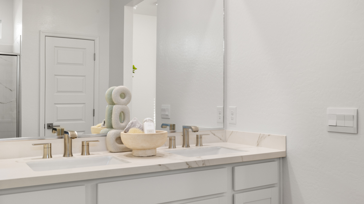 primary bathroom with dual vanities