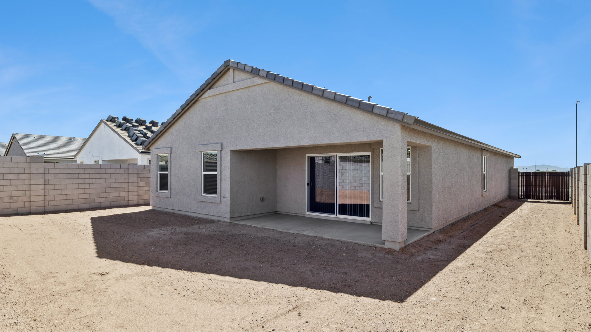 Large fenced-in backyard with a covered patio, perfect for outdoor entertaining.