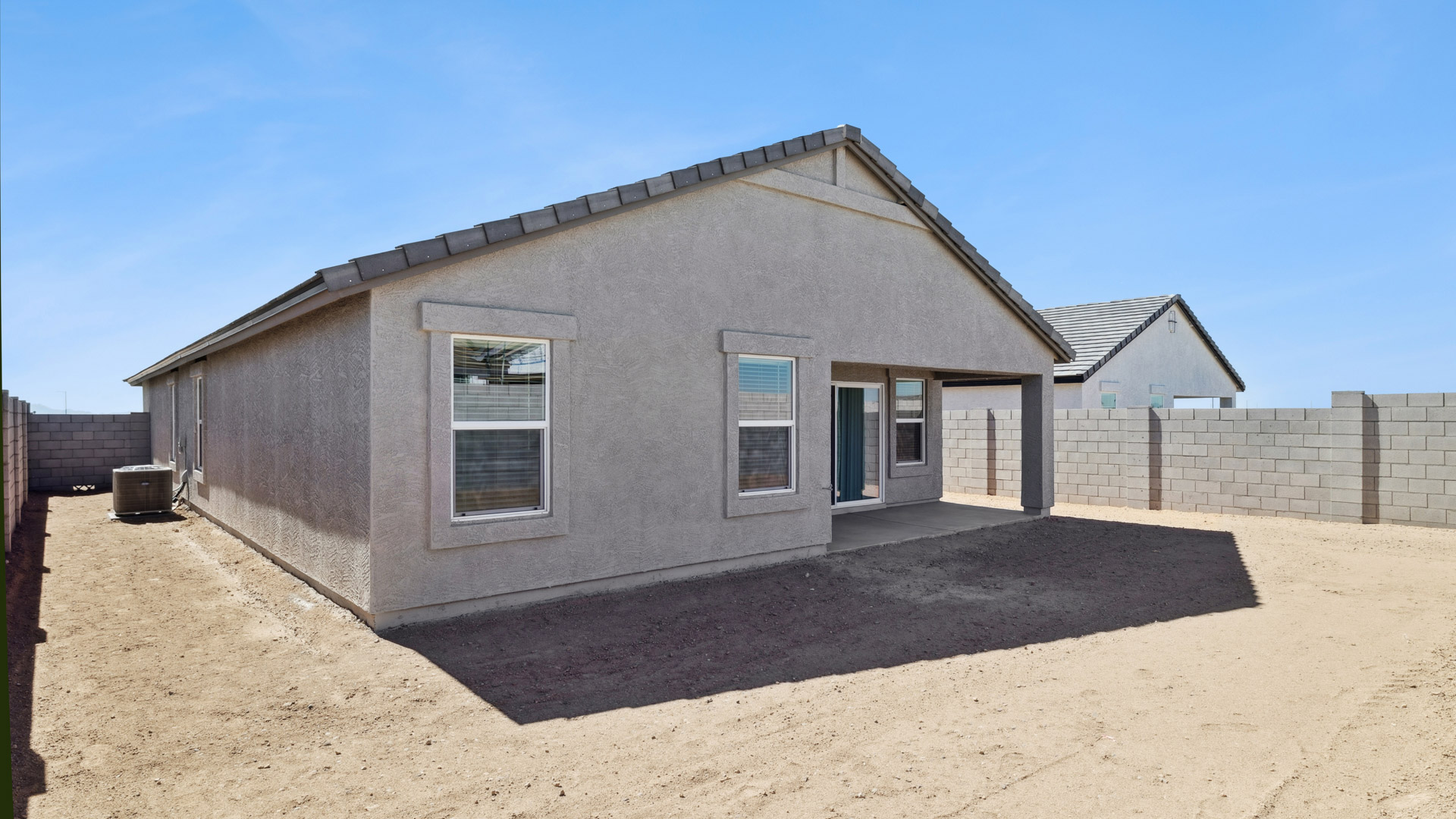 Large fenced-in backyard with a covered patio, perfect for outdoor entertaining.