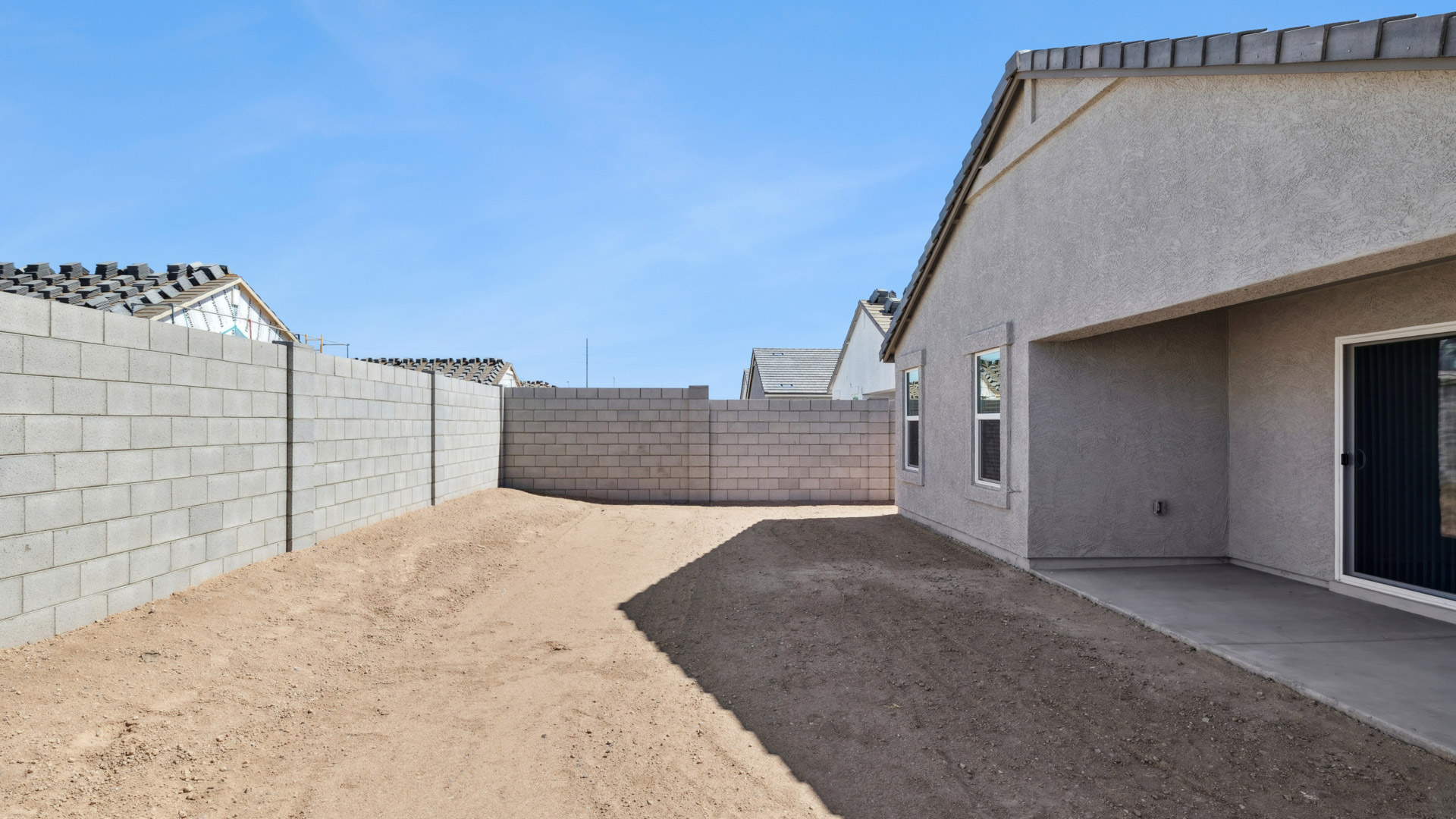 Large fenced-in backyard with a covered patio, perfect for outdoor entertaining.