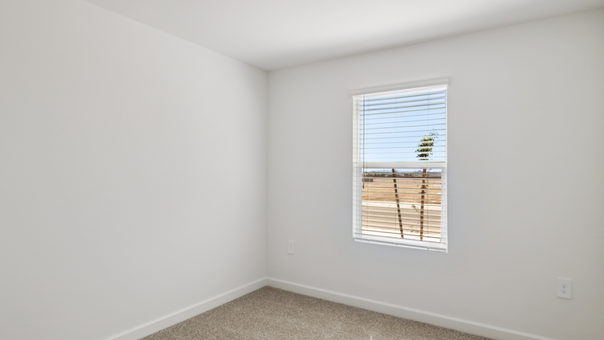 Comfortable guest bedroom featuring neutral-toned walls and a large closet.