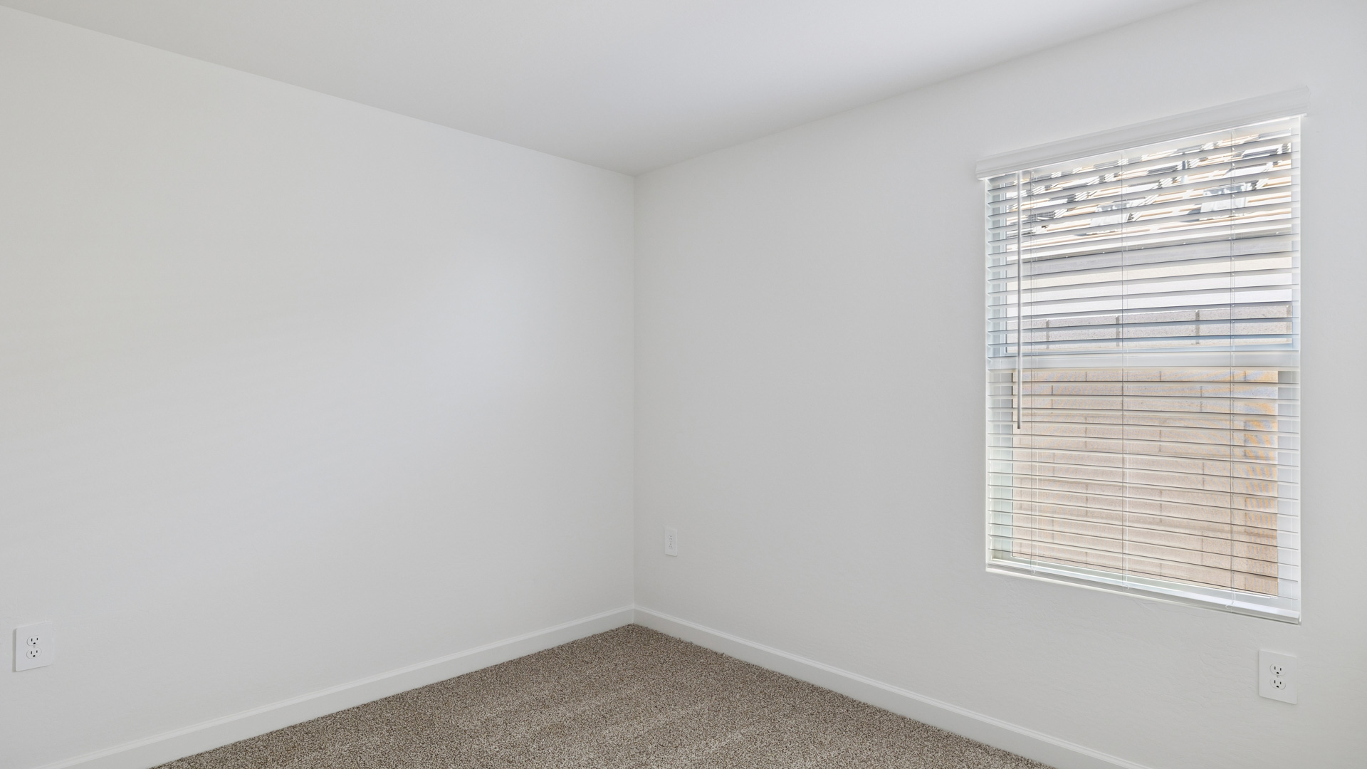 Comfortable guest bedroom featuring neutral-toned walls and a large closet.