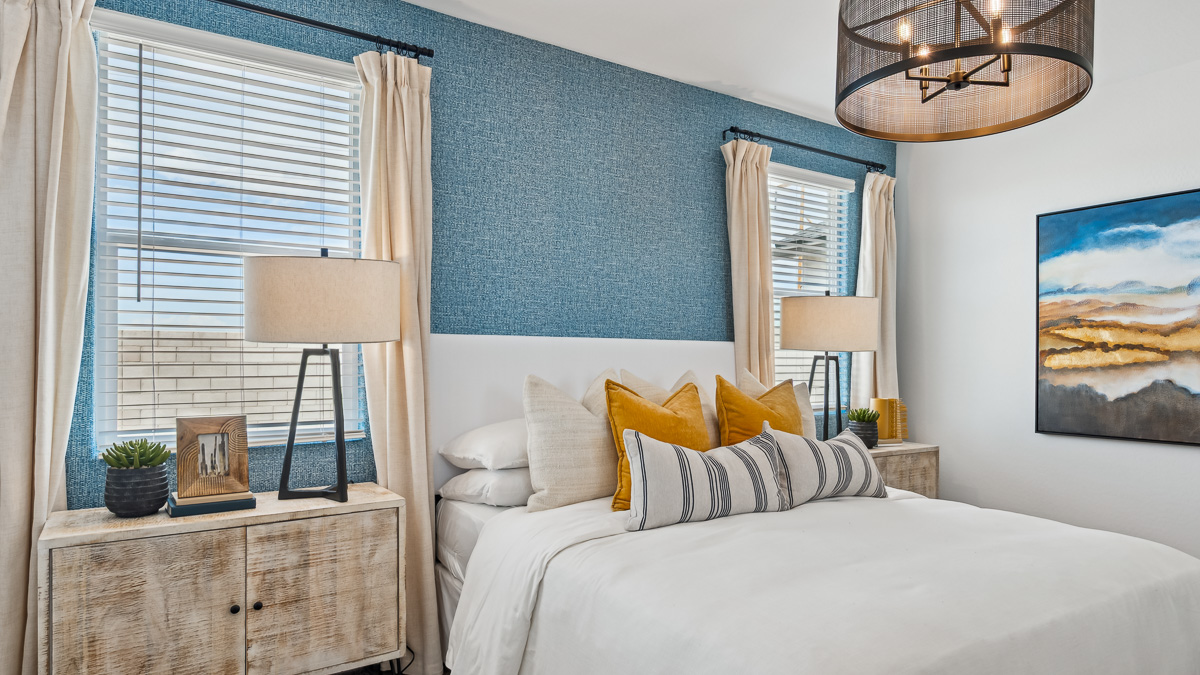 A spacious primary bedroom emphasizing open space and natural lighting.
