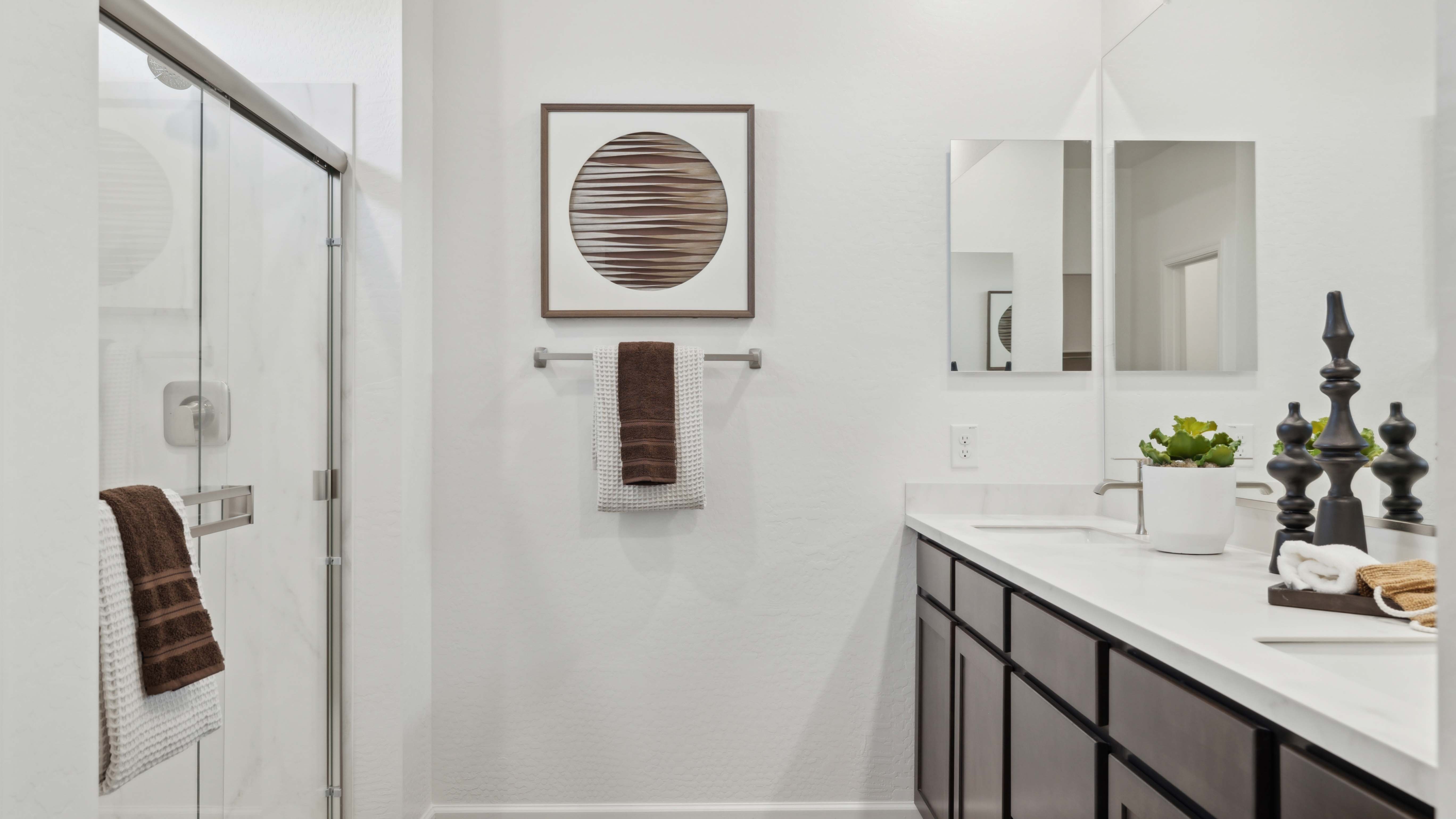 primary bathroom with dual vanities