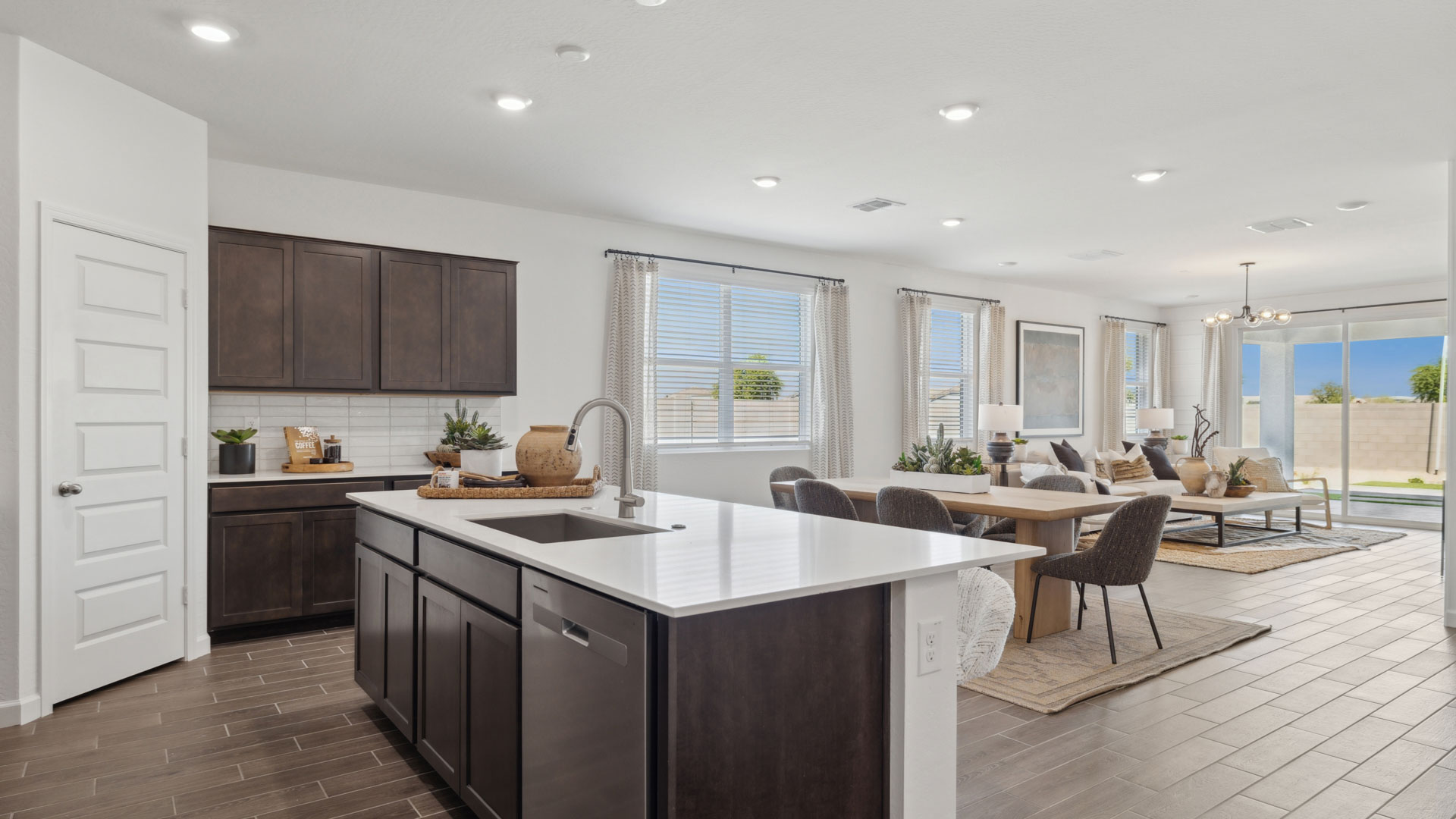 Spacious kitchen with island and stainless steel appliances.