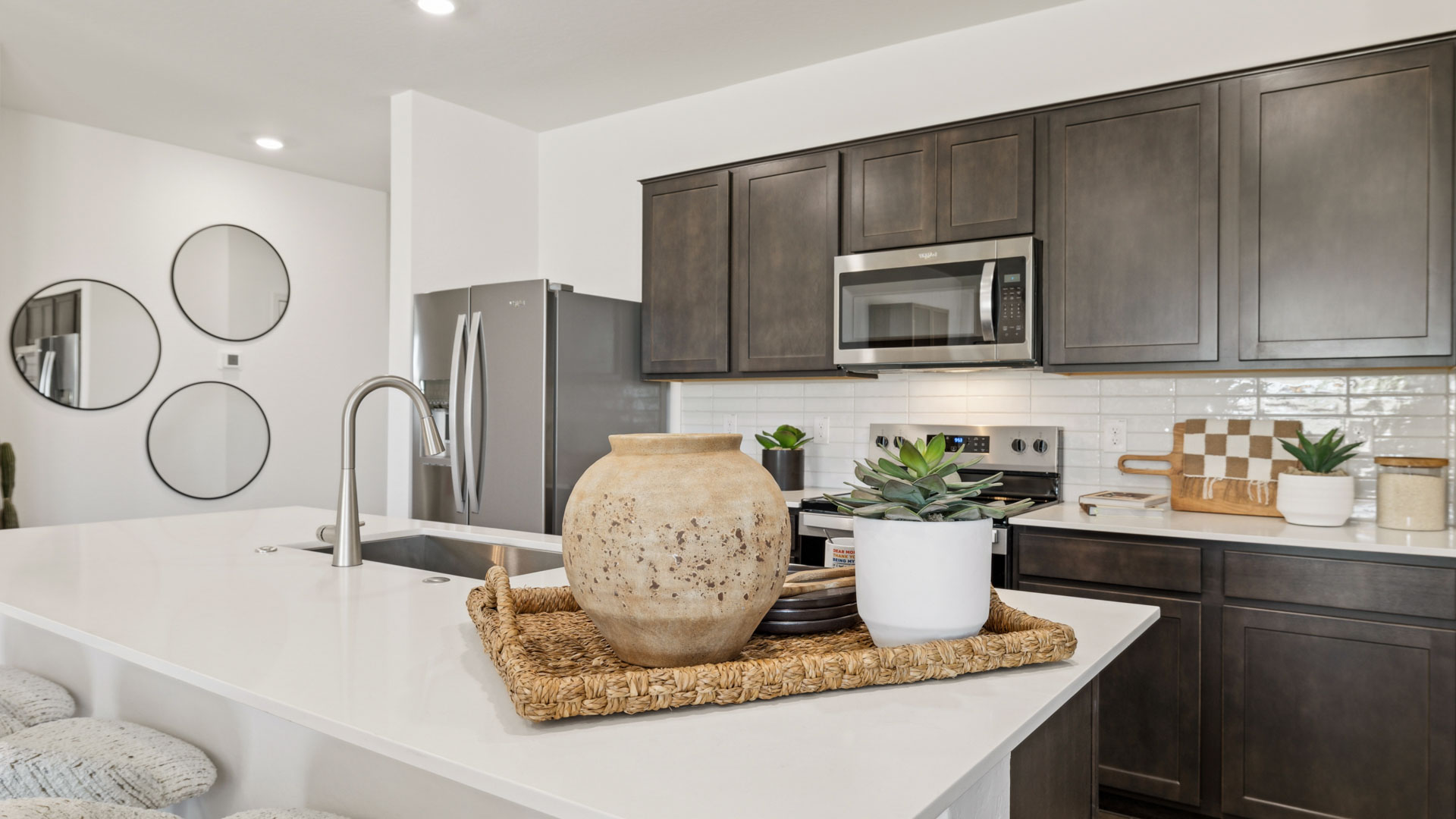 Spacious kitchen with island and stainless steel appliances.
