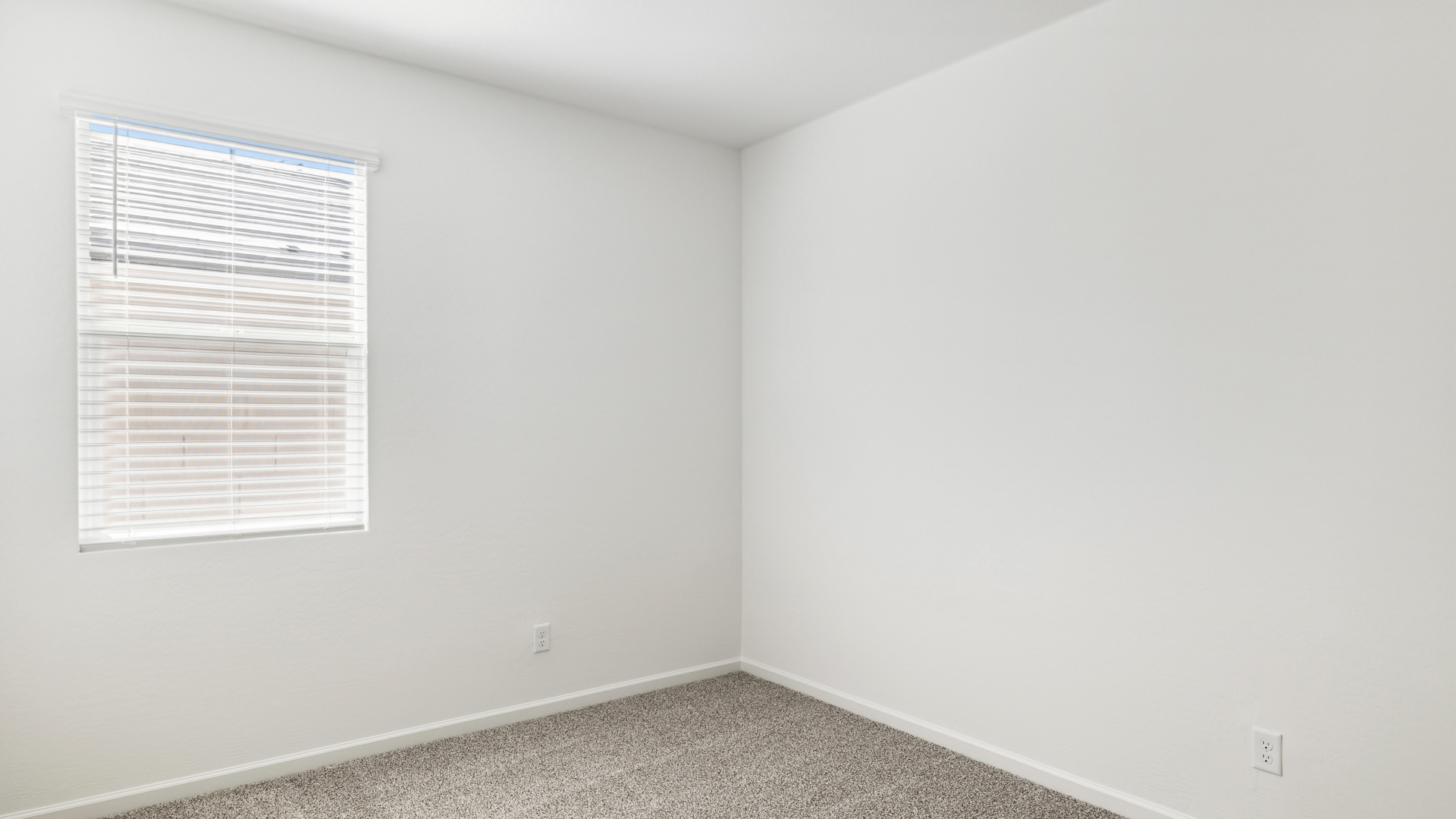Comfortable guest bedroom featuring neutral-toned walls and a large closet.