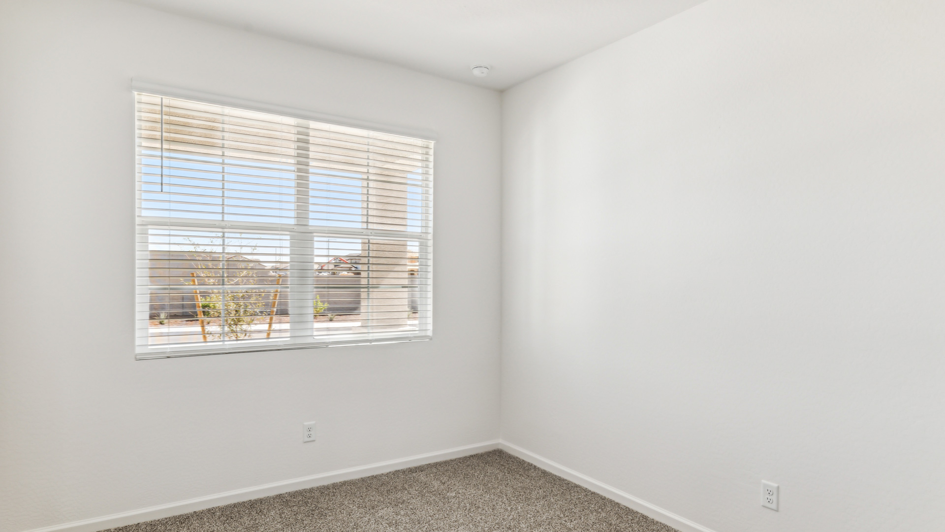 Comfortable guest bedroom featuring neutral-toned walls and a large closet.