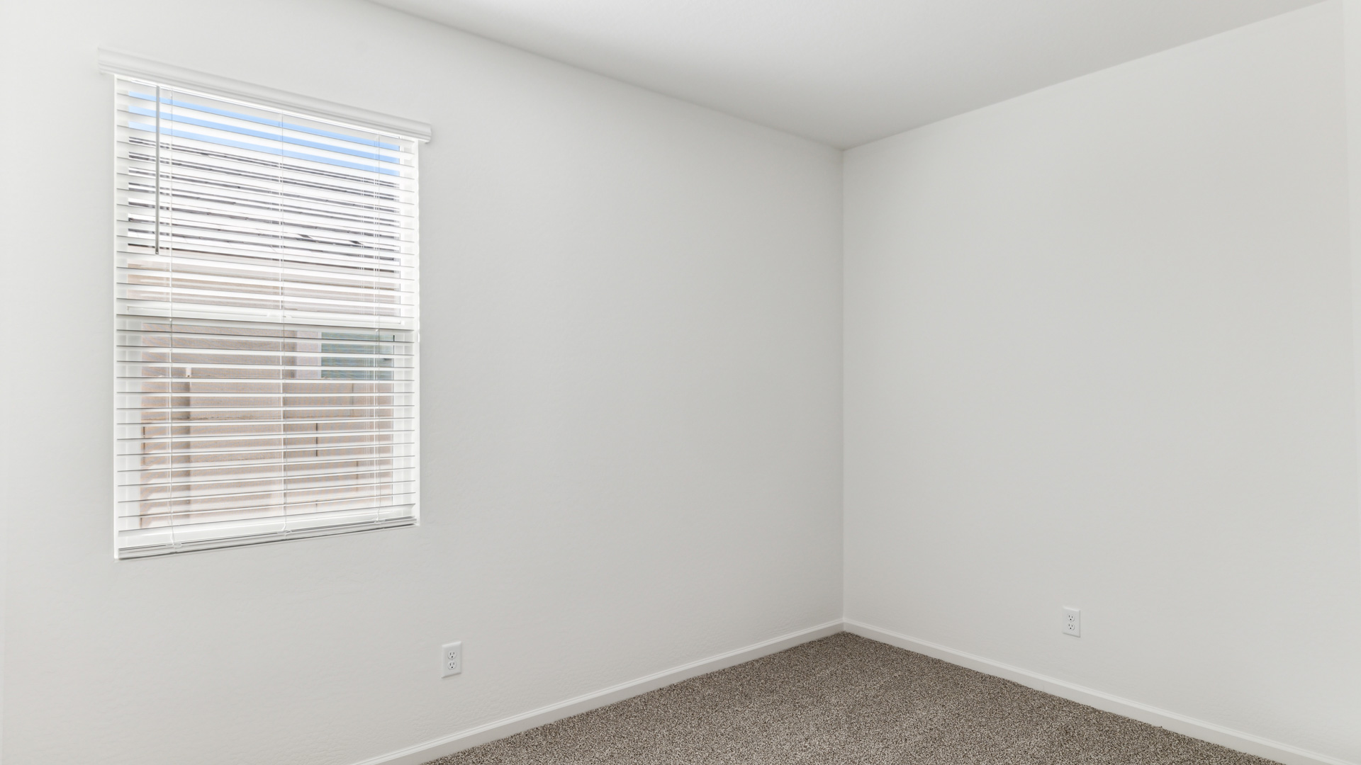Comfortable guest bedroom featuring neutral-toned walls and a large closet.