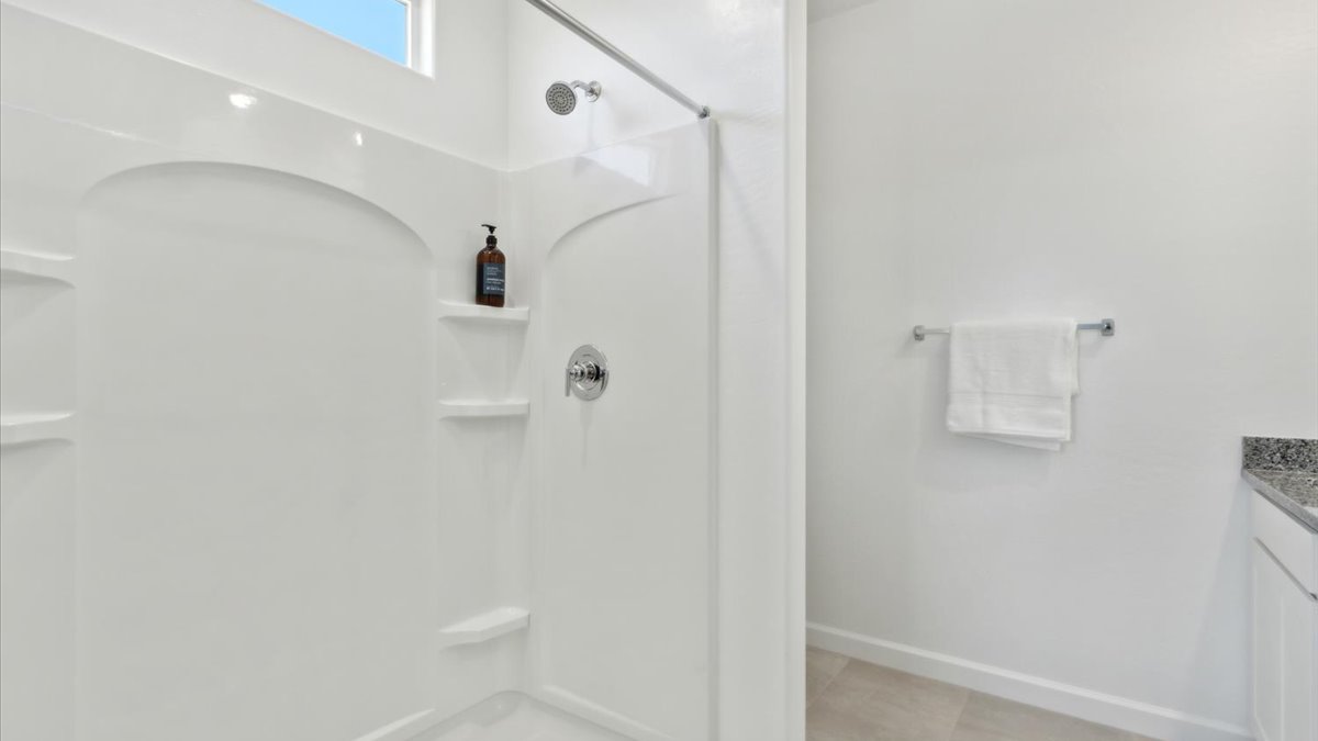 primary bathroom with dual vanities