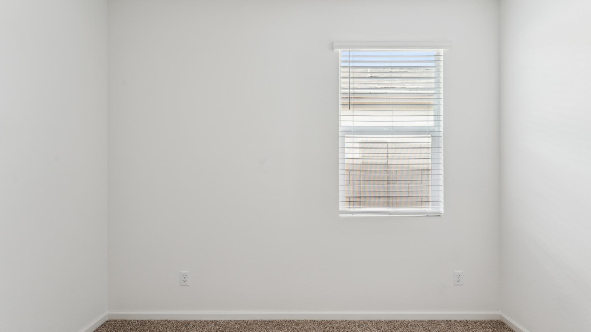 Comfortable guest bedroom featuring neutral-toned walls and a large closet.