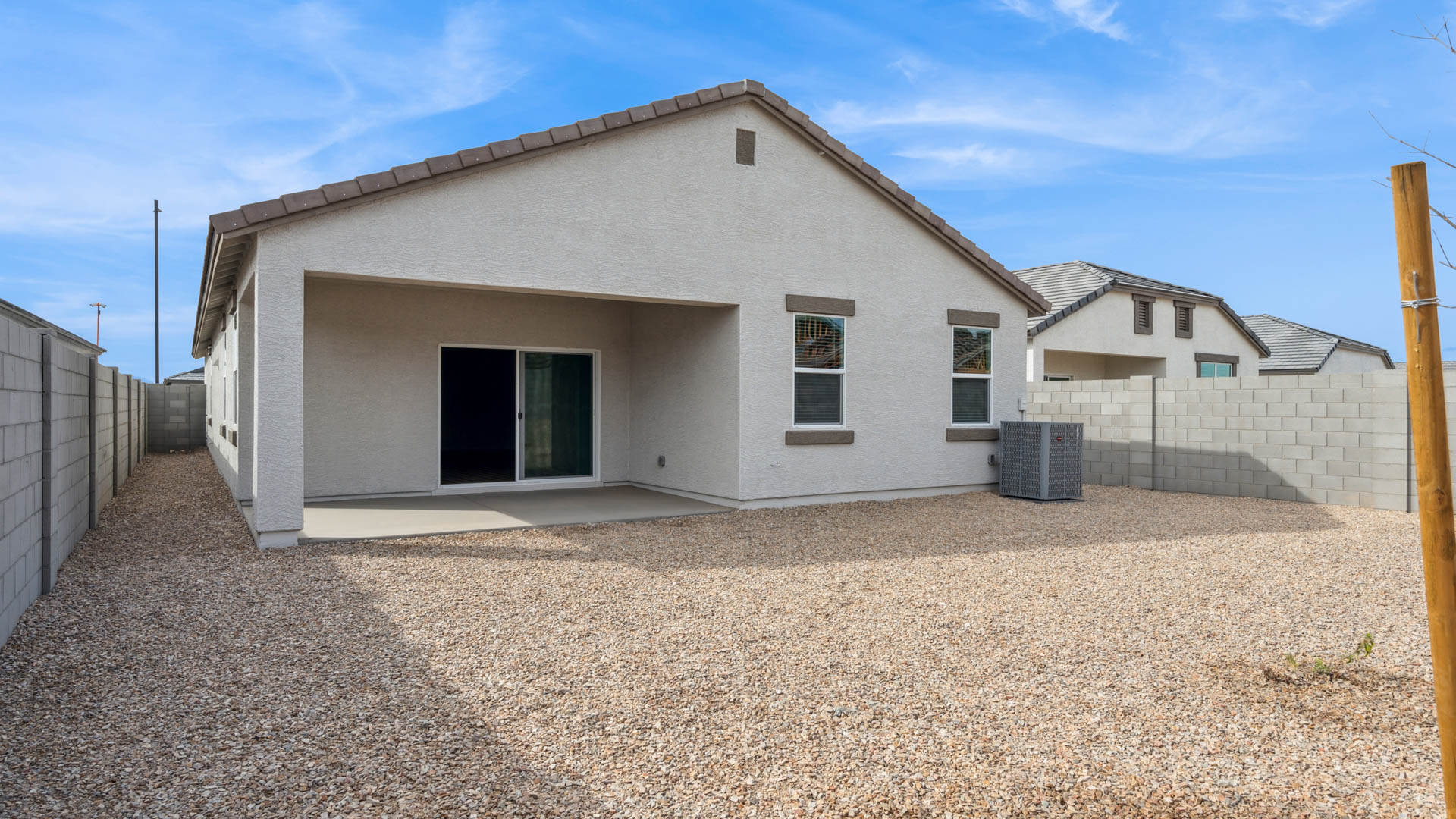 Large fenced-in backyard with a covered patio, perfect for outdoor entertaining.
