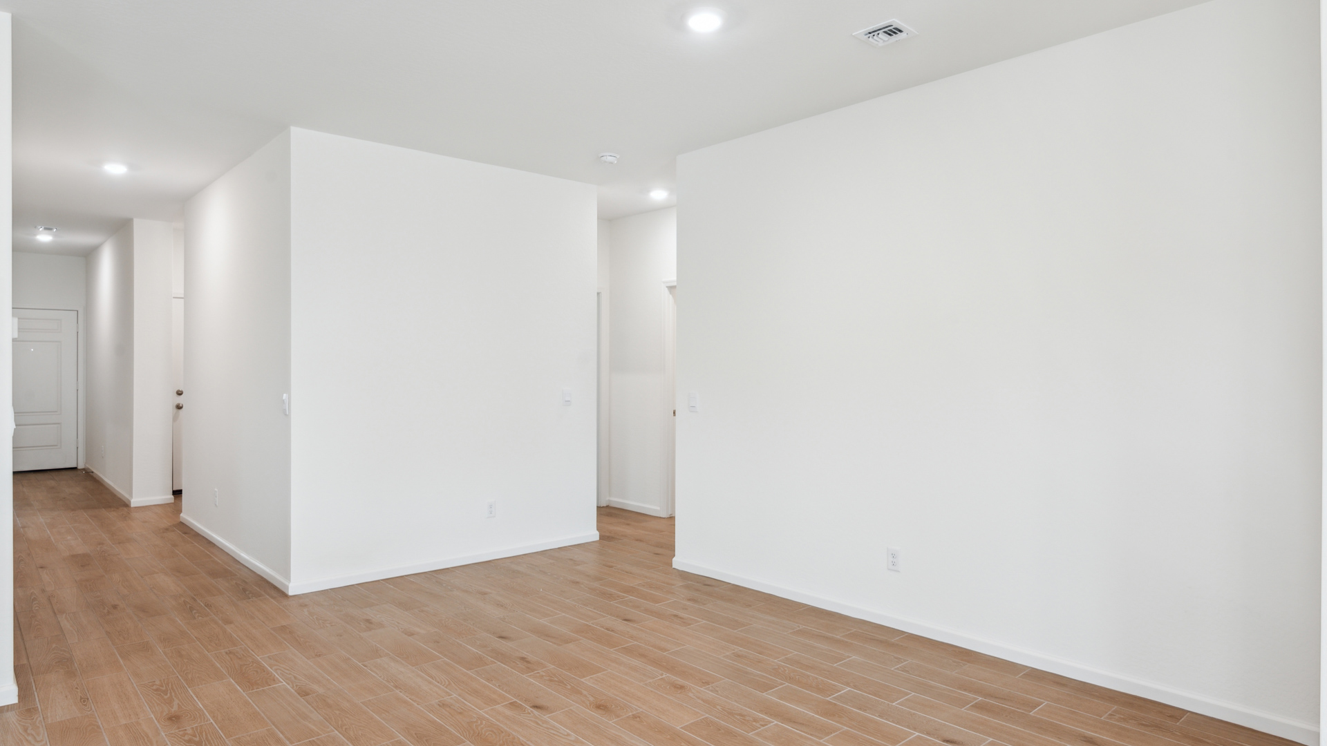 A well-organized living room that includes a kitchen and dining area, creating a warm and welcoming environment for gatherings.