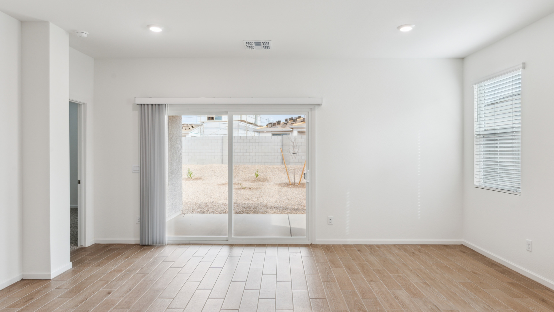 A well-organized living room that includes a kitchen and dining area, creating a warm and welcoming environment for gatherings.