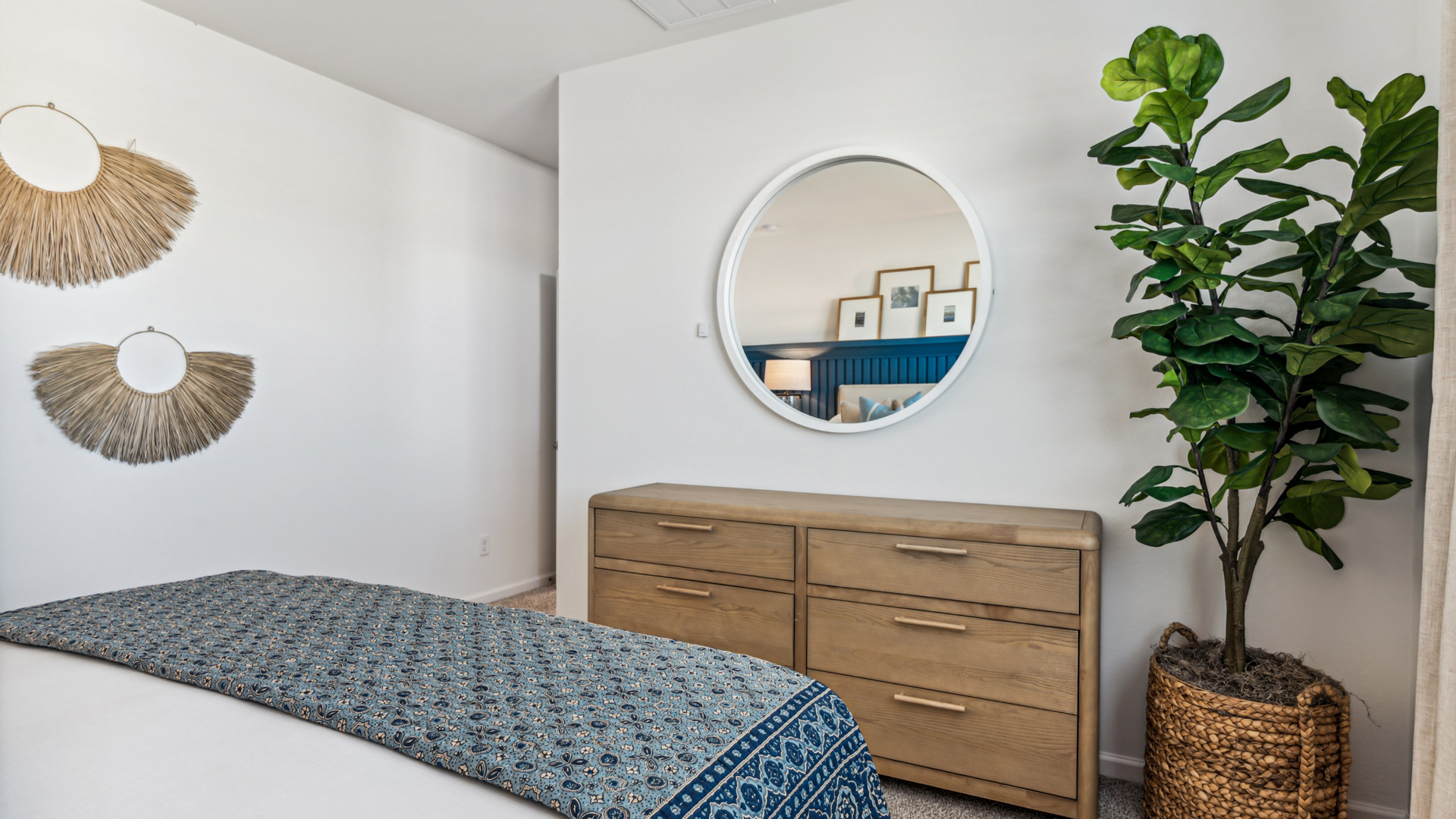 A spacious primary bedroom emphasizing open space and natural lighting.