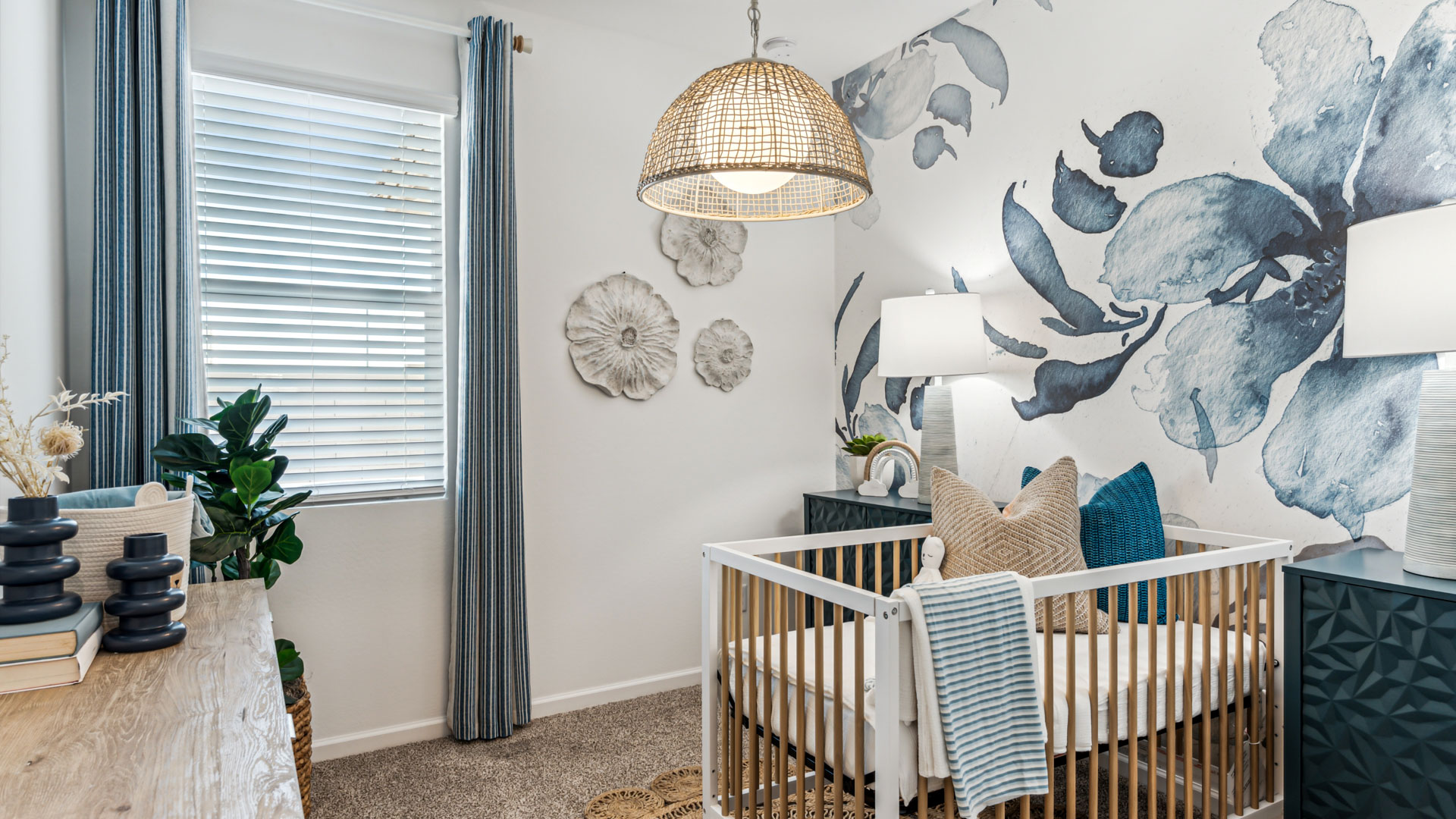 A cozy baby's room featuring a crib, a comfortable chair, and a bright window allowing natural light to enter.
