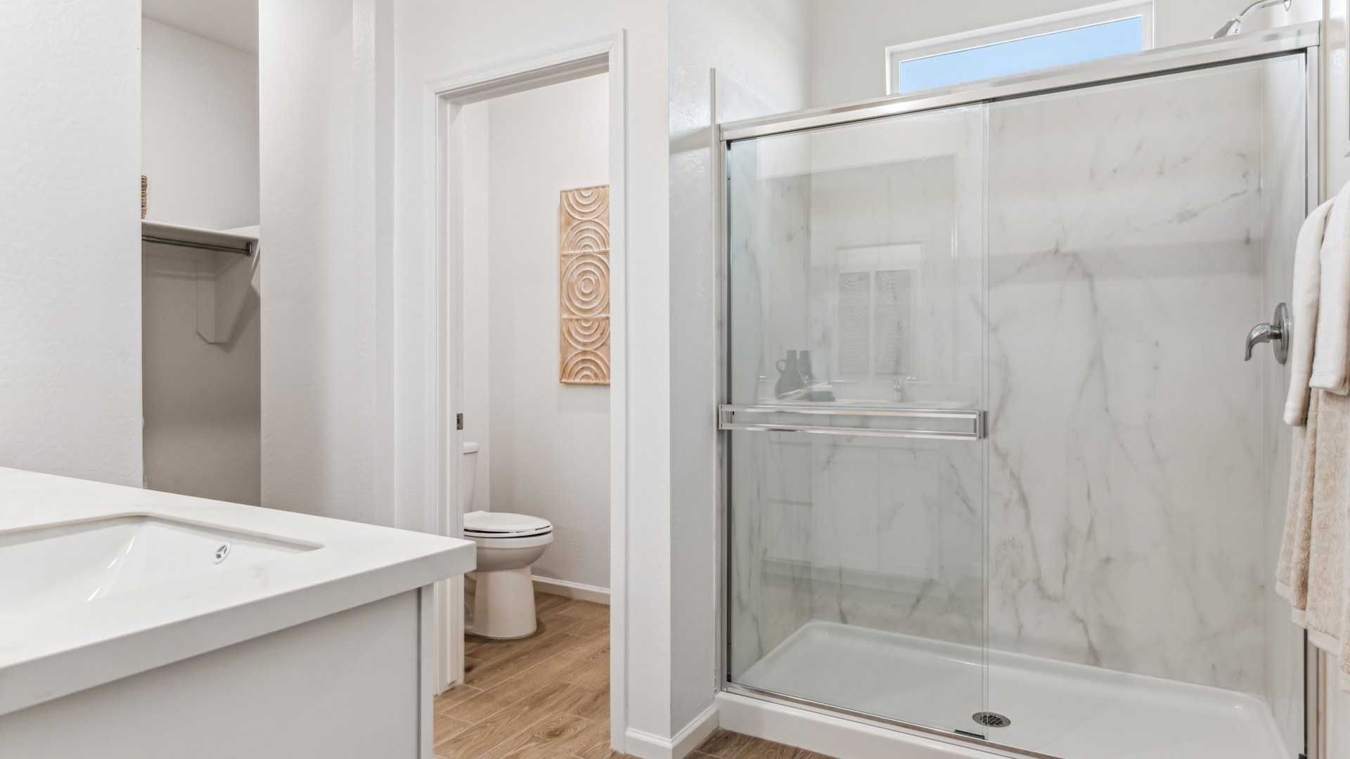 Primary bathroom with dual vanities.