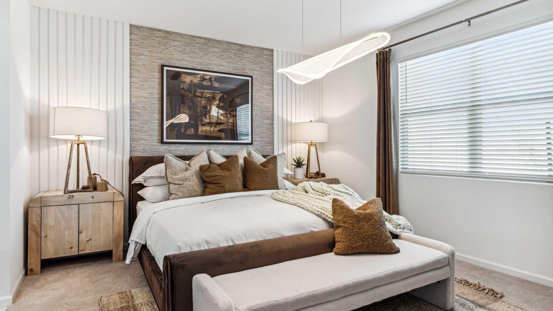 A spacious primary bedroom emphasizing open space and natural lighting.