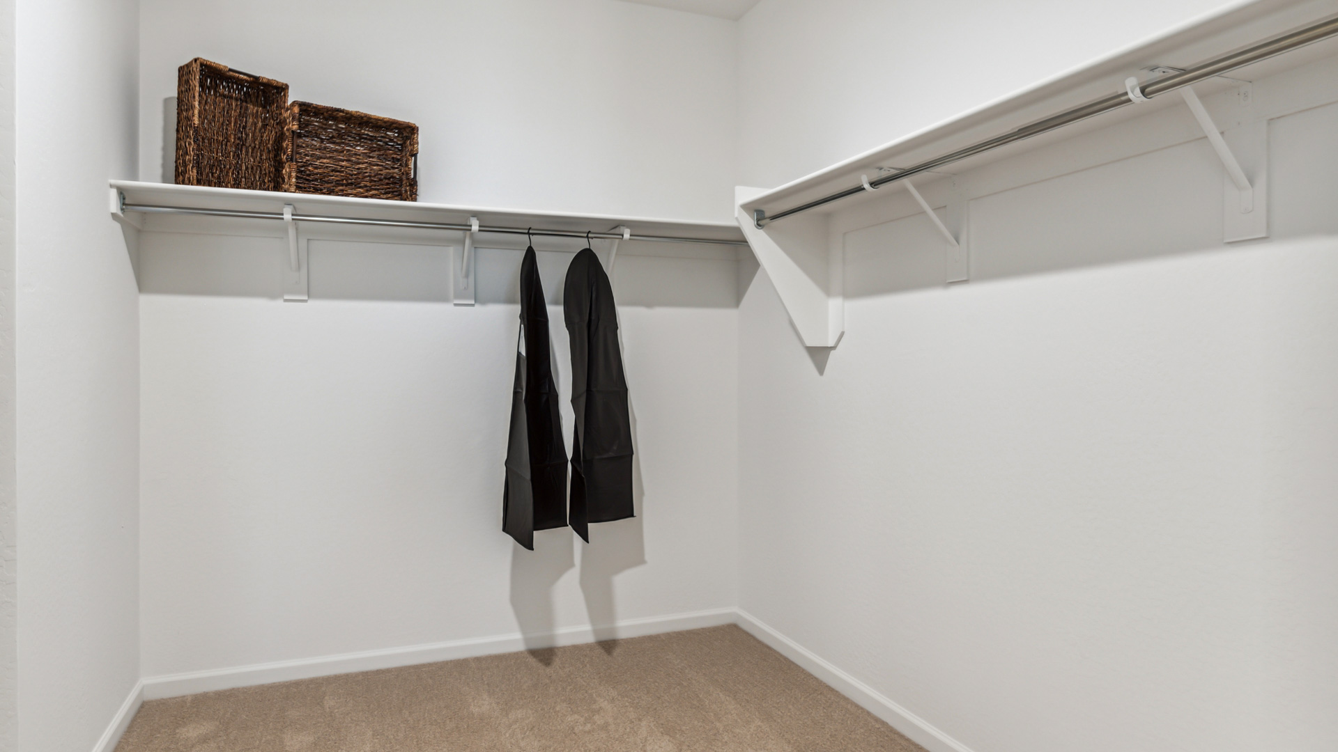 Comfortable guest bedroom featuring neutral-toned walls and a large closet.