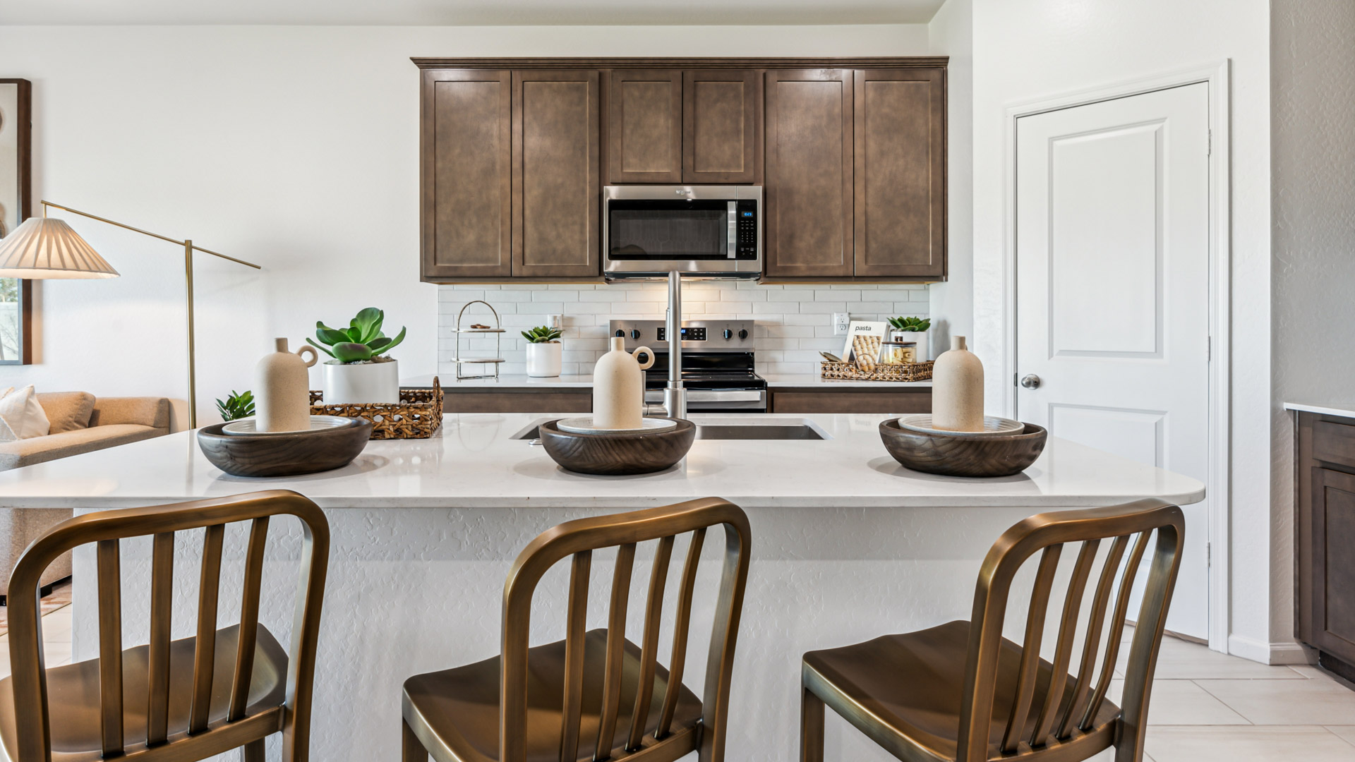 Spacious kitchen with island and stainless-steel appliances.
