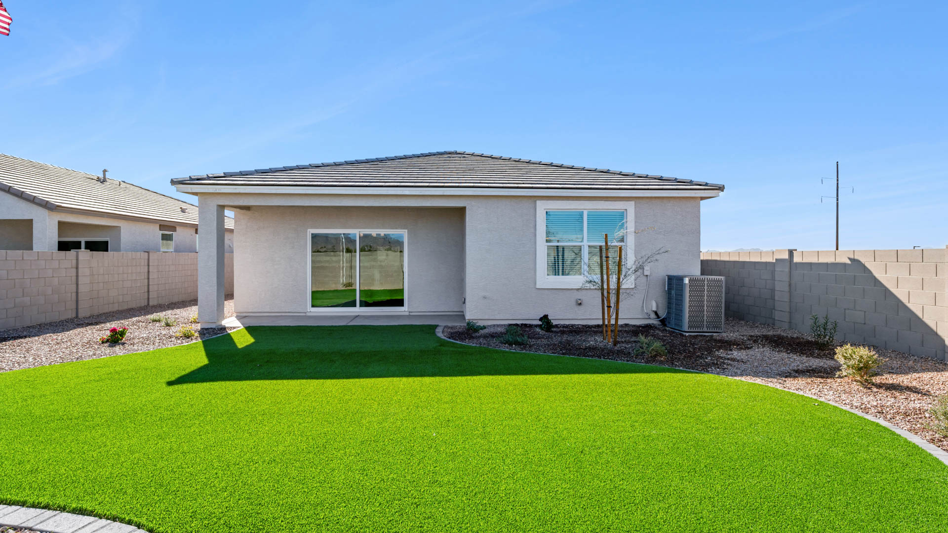 Large fenced-in backyard with a covered patio, perfect for outdoor entertaining.