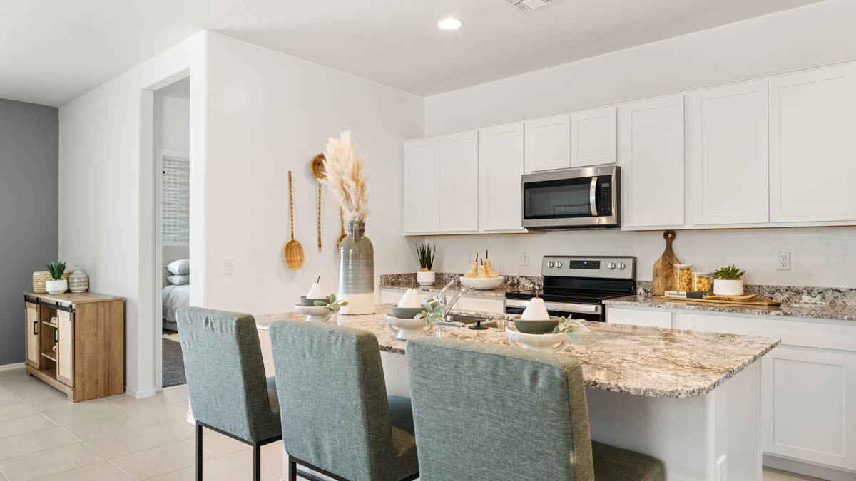 Spacious kitchen with island countertops and stainless steel appliances.
