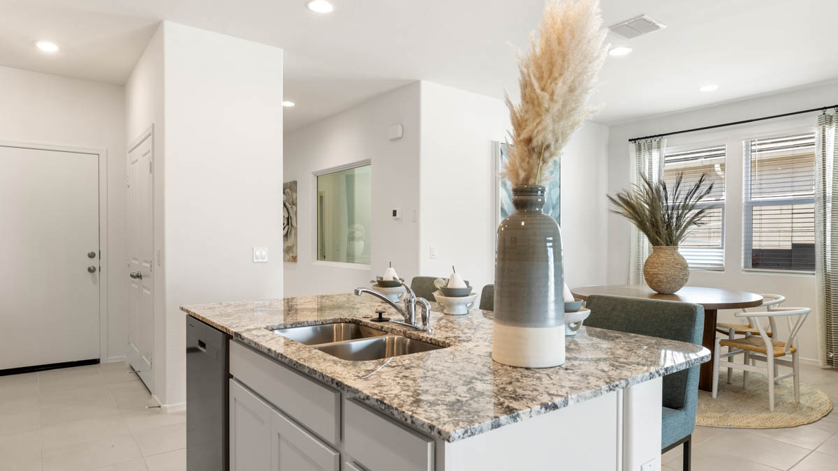 Spacious kitchen with island countertops and stainless steel appliances.